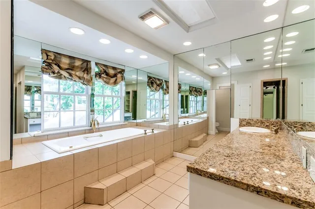 a large bathroom with a large tub and sink