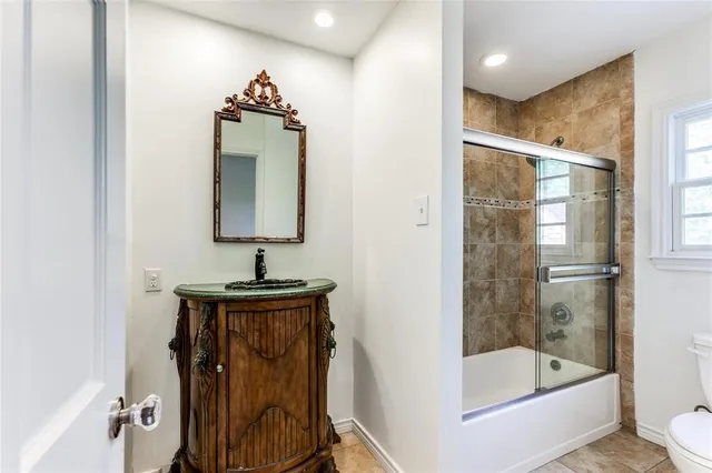 a bathroom with a sink mirror toilet and bathtub