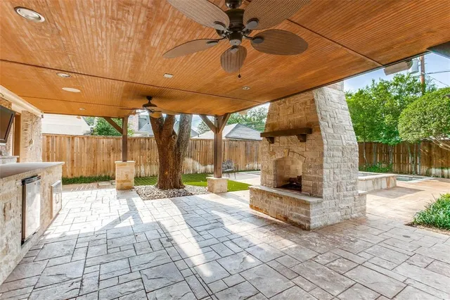 a view of a patio with table and chairs under an umbrella