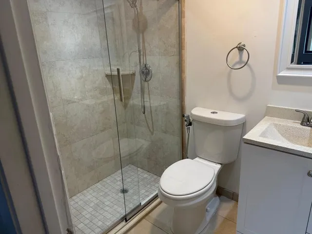 a bathroom with a toilet and a shower