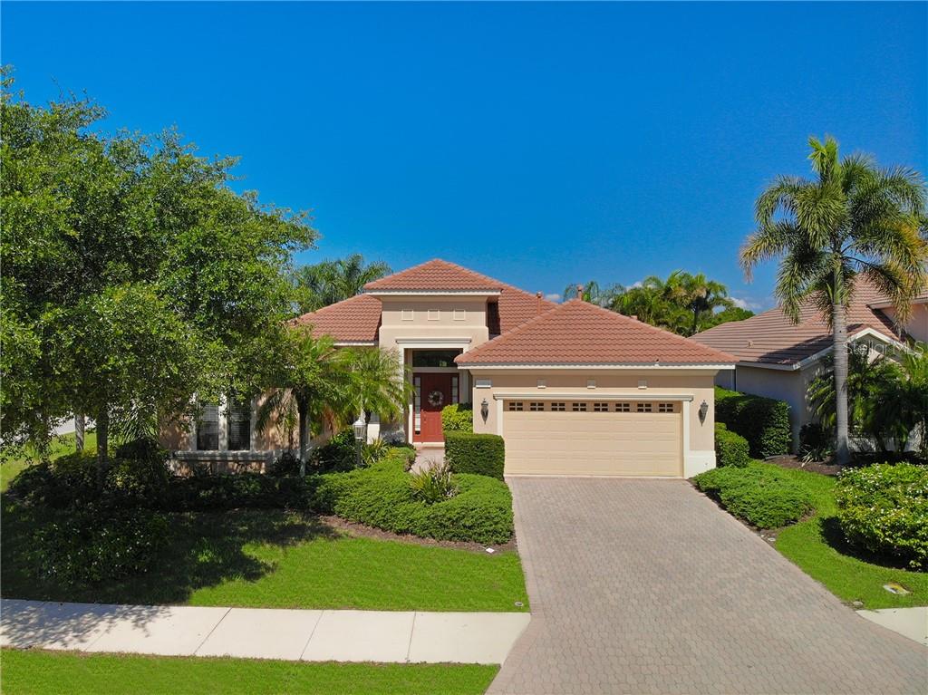 13994 Siena Loop Lakewood Ranch, FL 34202 - Photo 1 of 1 a front view of a house with a yard and garage