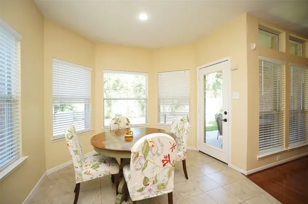 a dining room with furniture and window