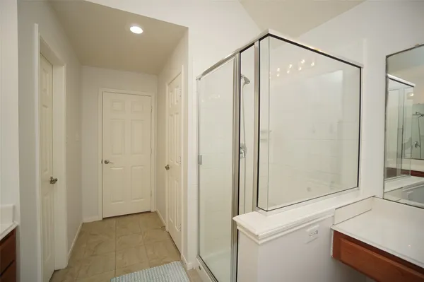a bathroom with a shower and a sink