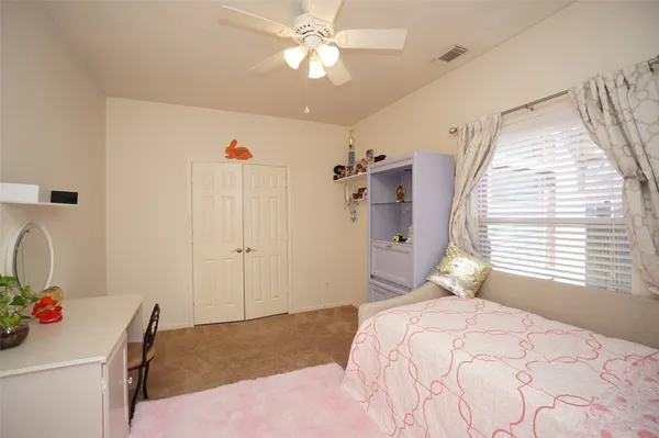 a bedroom with a bed and a dresser