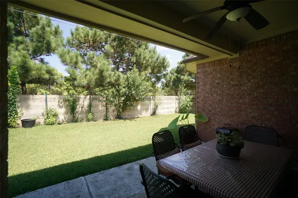 a view of a porch with furniture and a yard