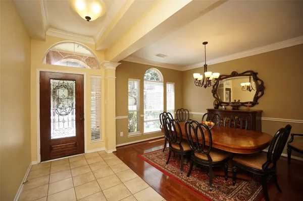 a view of a dining room with furniture and chandelier