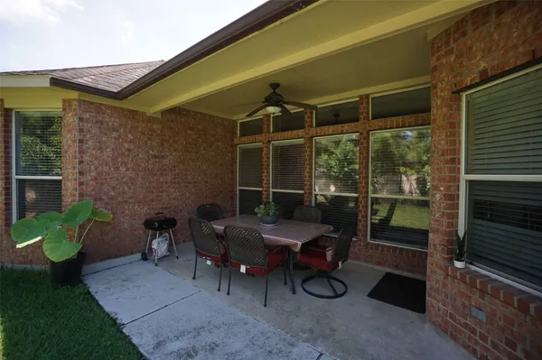 a view of a patio with table and chairs and potted plants