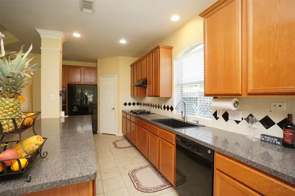 a kitchen with stainless steel appliances granite countertop sink stove and cabinets