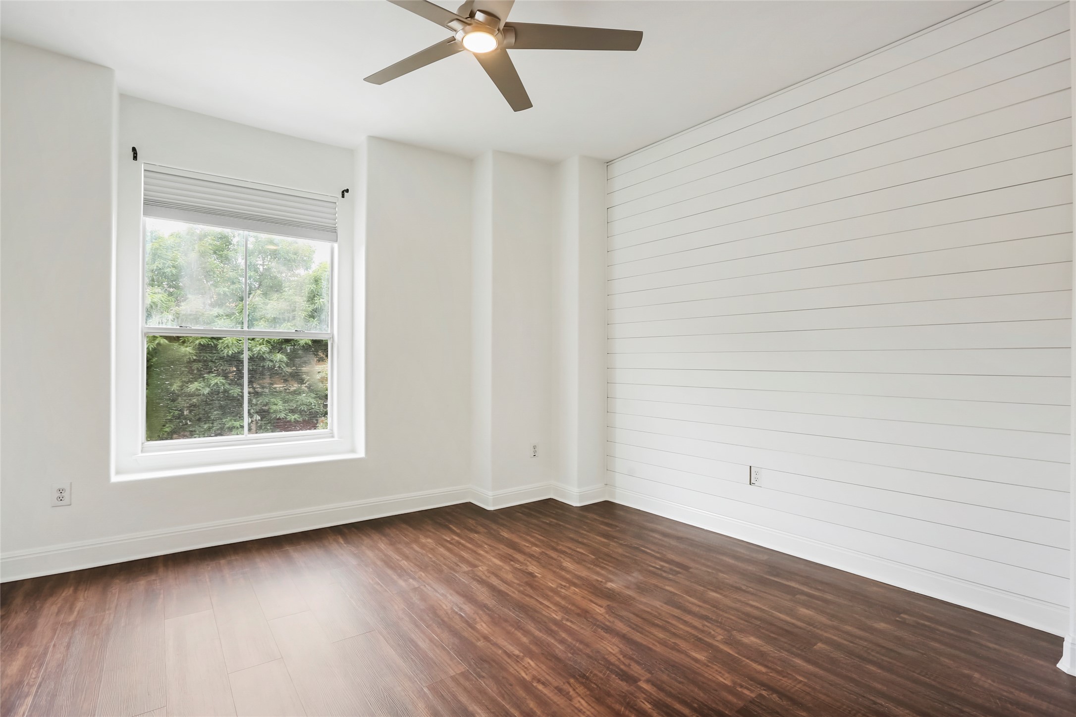 3406 Menchaca Road, Unit 19 Austin, TX 78704 - Photo 20 of 25 Rich wood flooring contrasts beautifully with crisp shiplap paneling and abundant natural light.