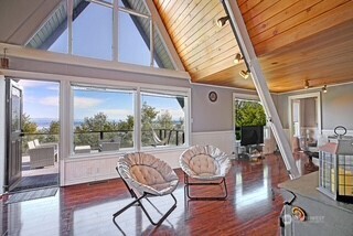 a dining room with wooden floor table and chairs