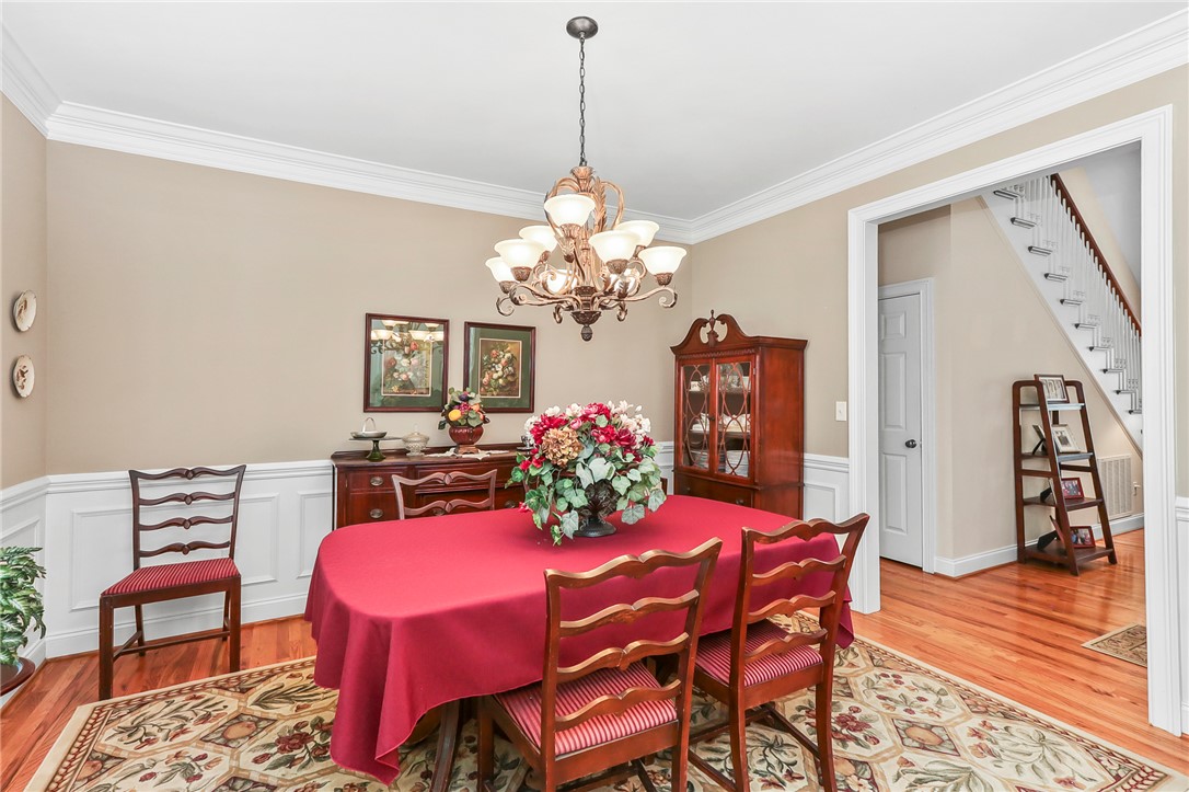 103 C-10-147D Anderson, SC 29621 - Photo 6 of 49 Hardwood floors and classic crown molding highlight this inviting dining room, perfect for entertaining.