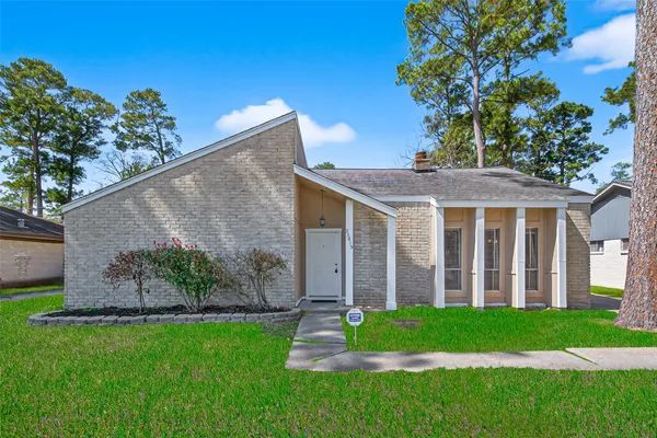 a view of a house with a yard and plants