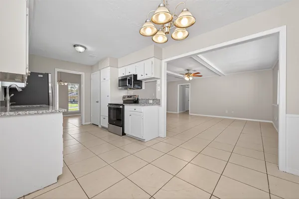 a kitchen with cabinets and steel stainless steel appliances