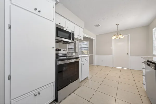 a kitchen with stainless steel appliances a refrigerator and a stove top oven