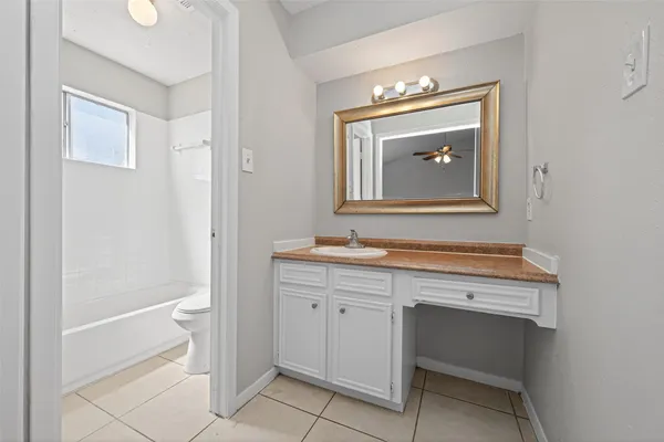 a bathroom with a sink a toilet and mirror