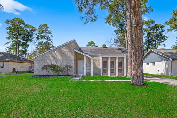 a front view of a house with a garden and yard
