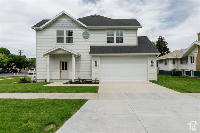 195 West 300 North Logan, UT 84321 - Photo 2 of 20 View of front of property featuring a front lawn, concrete driveway, a shingled roof, and a garage