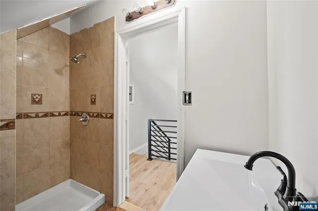 a close view of a bathroom sink and shower