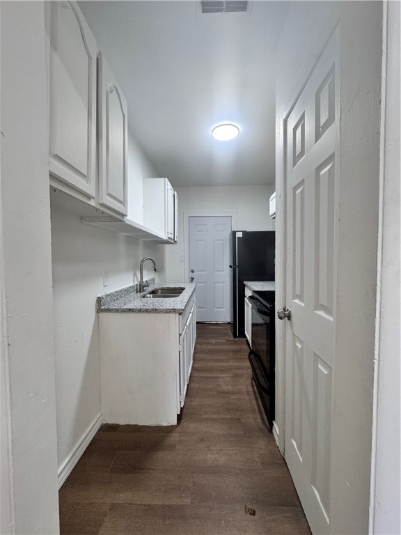 907 Elizabeth Street, Unit 4 Corpus Christi, TX 78404 - Photo 6 of 11 a kitchen with sink a microwave and cabinets