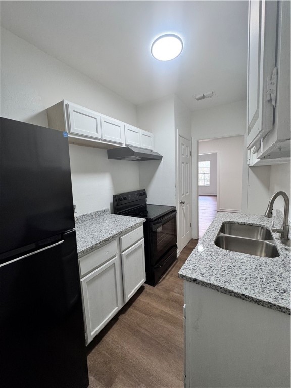 907 Elizabeth Street, Unit 4 Corpus Christi, TX 78404 - Photo 7 of 11 a kitchen with granite countertop a sink stove and refrigerator