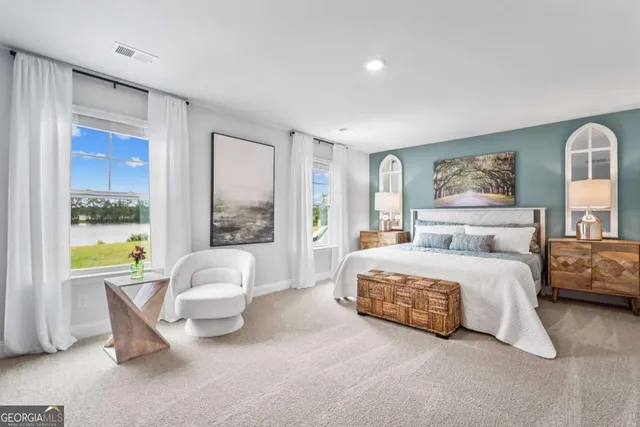 a spacious bedroom with a bed and glass windows