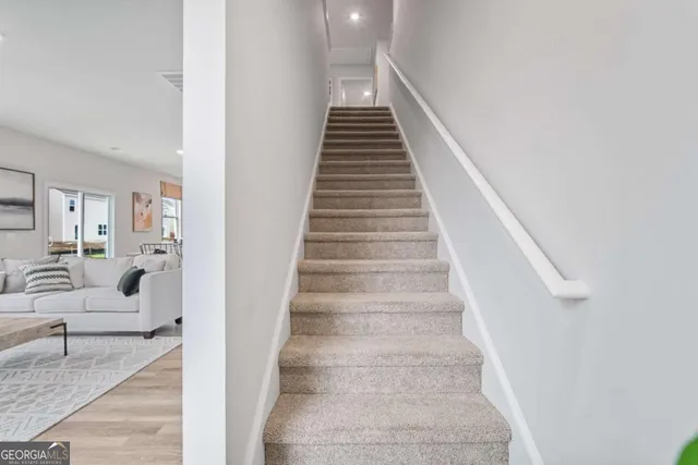 a view of entryway and hall with wooden floor
