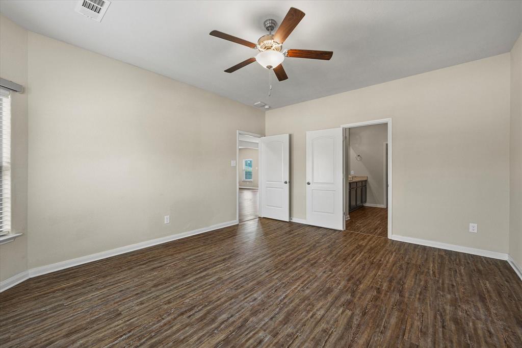 2212 Georgetown Street Princeton, TX 75407 - Photo 14 of 31 an empty room with wooden floor and ceiling fan
