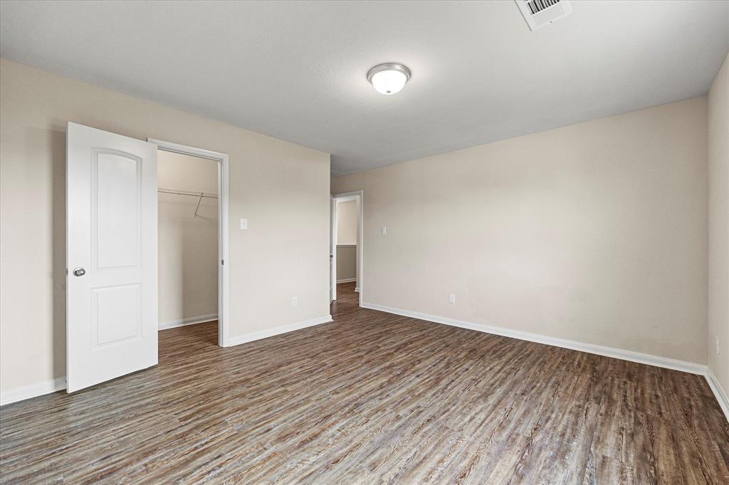 2212 Georgetown Street Princeton, TX 75407 - Photo 21 of 31 a view of an empty room with wooden floor