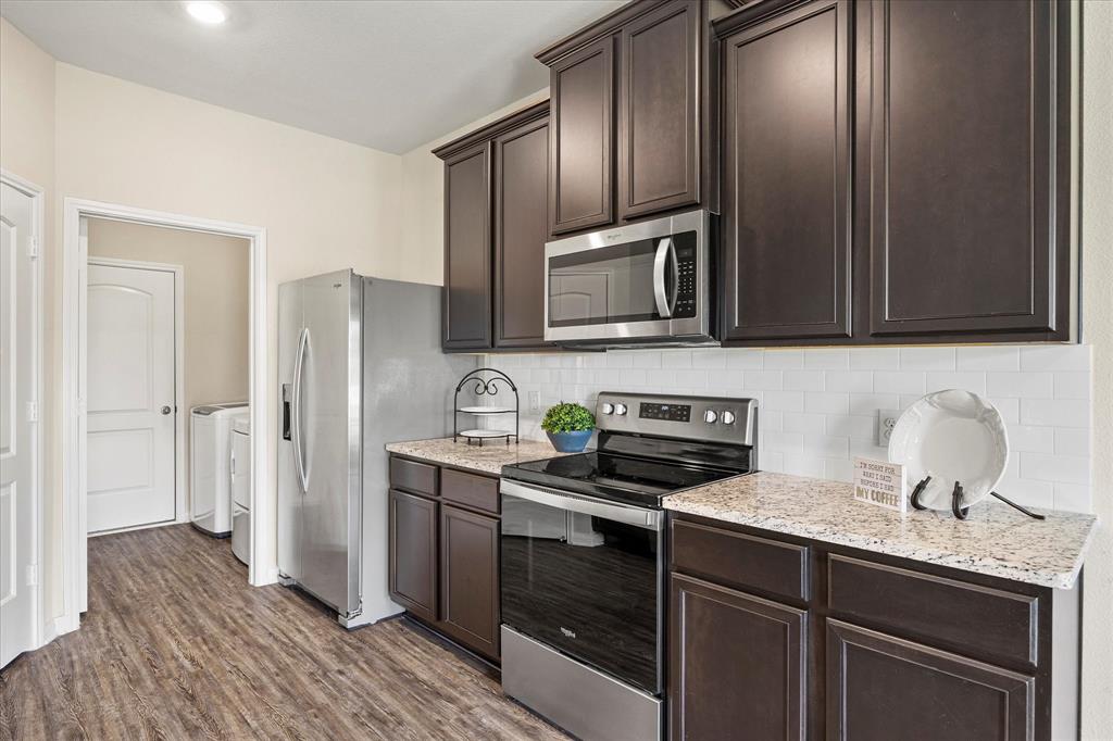 2212 Georgetown Street Princeton, TX 75407 - Photo 8 of 31 a kitchen with stainless steel appliances granite countertop a sink stove and refrigerator