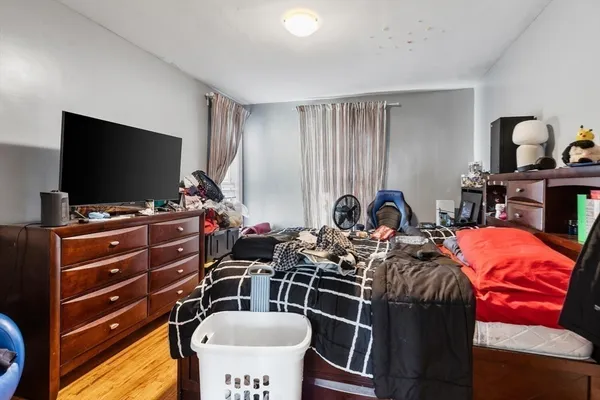 a bedroom with furniture and a flat screen tv