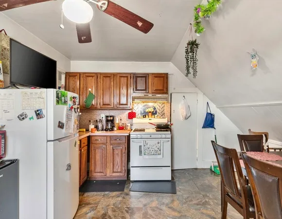 a view of a kitchen with fridge and workspace