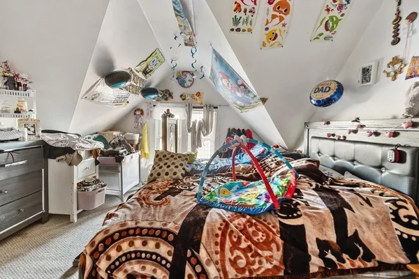 a bedroom with bed and a view of room