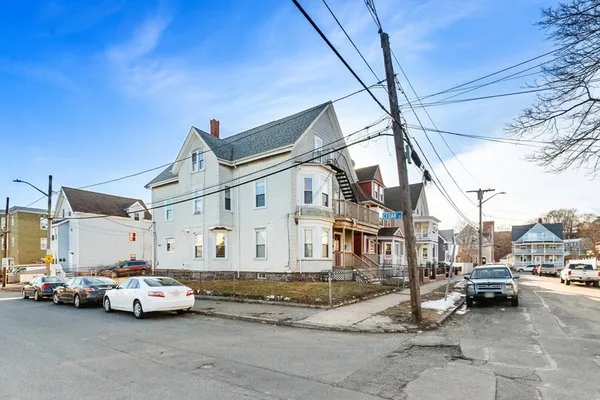 a view of a cars is parked in front of a house