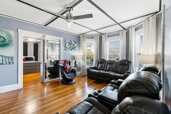 a living room with furniture and a wooden floor