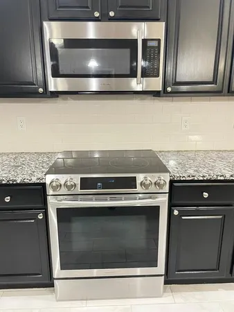 a stove top oven sitting inside of a kitchen