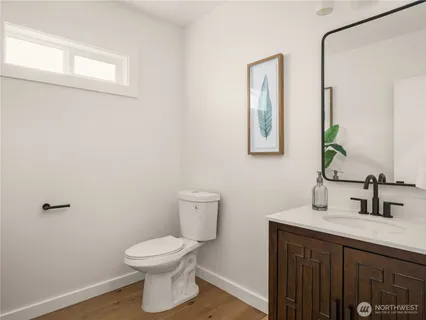 a bathroom with a toilet a sink and mirror
