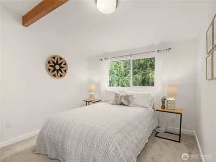 a bedroom with a bed and a window