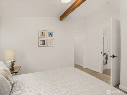 a bedroom with a bed and a painting on the wall