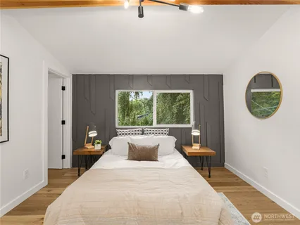 a spacious bedroom with a bed and a window