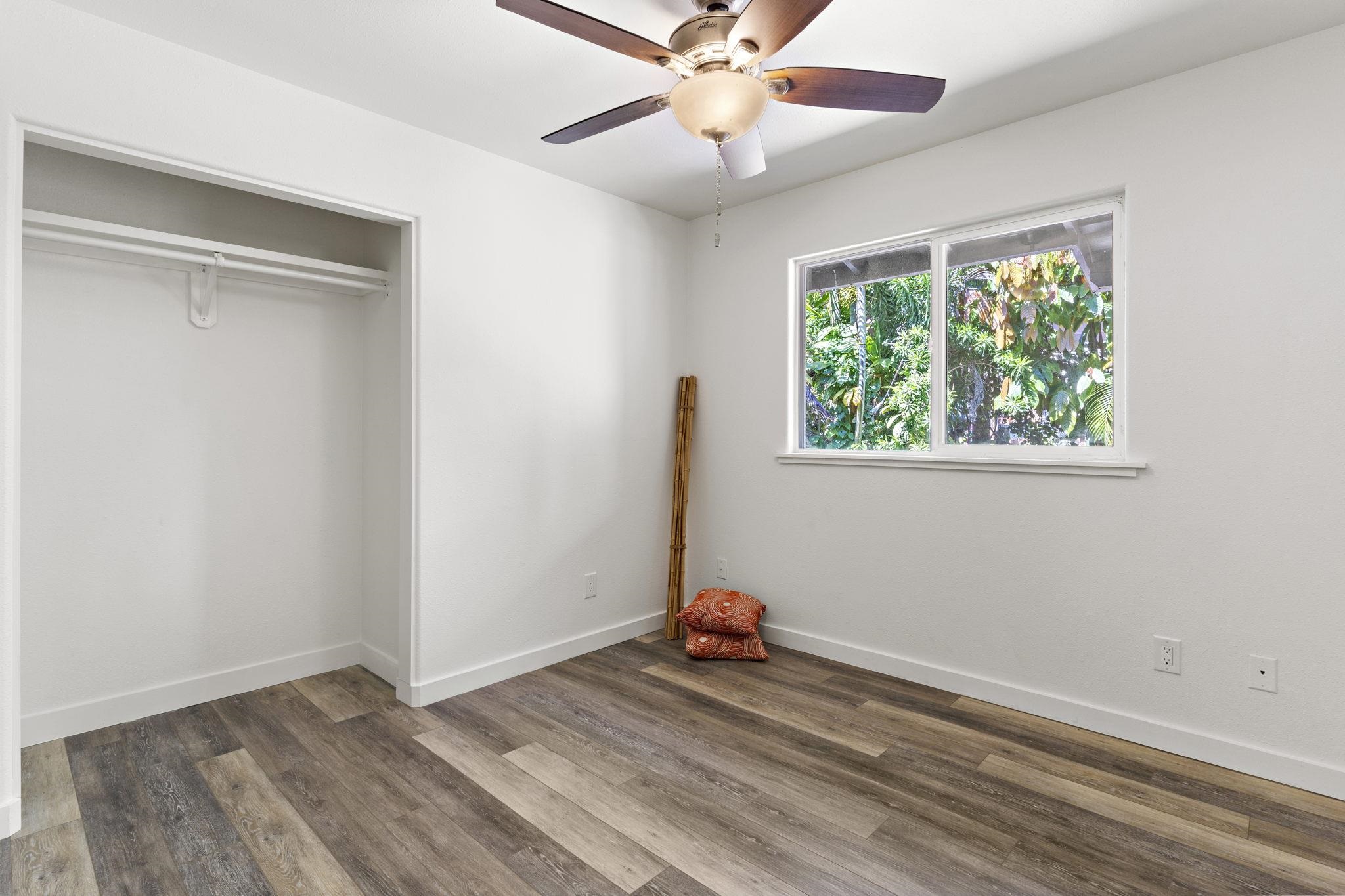 14 Kahiapo Place Haiku, HI 96708 - Photo 19 of 30 an empty room with wooden floor fan and windows