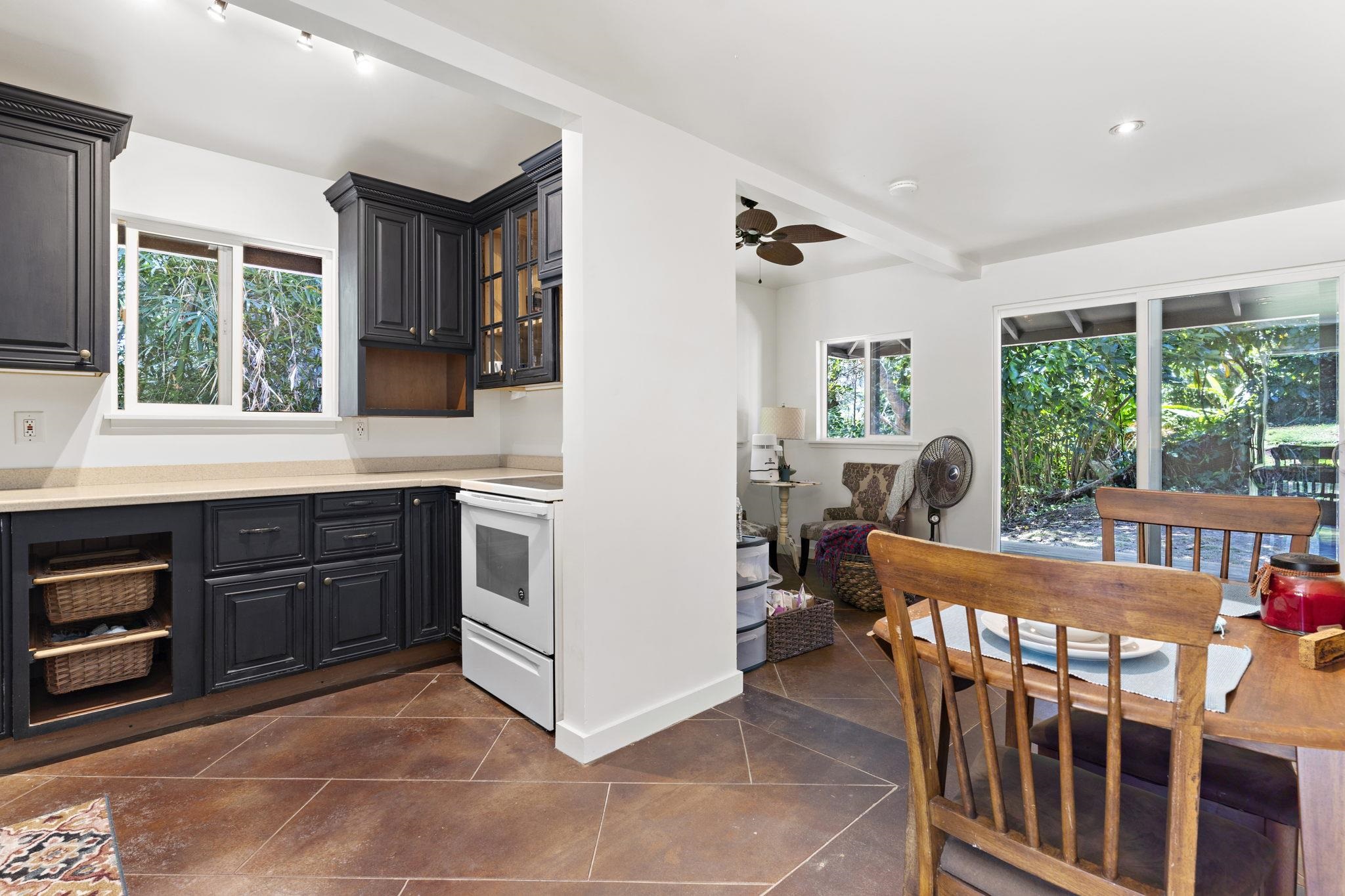 14 Kahiapo Place Haiku, HI 96708 - Photo 25 of 30 a kitchen with stainless steel appliances kitchen island granite countertop a stove a sink and a refrigerator