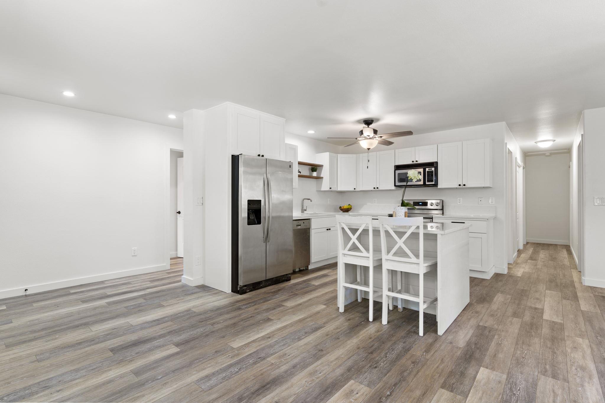 14 Kahiapo Place Haiku, HI 96708 - Photo 7 of 30 a large kitchen with white cabinets and stainless steel appliances