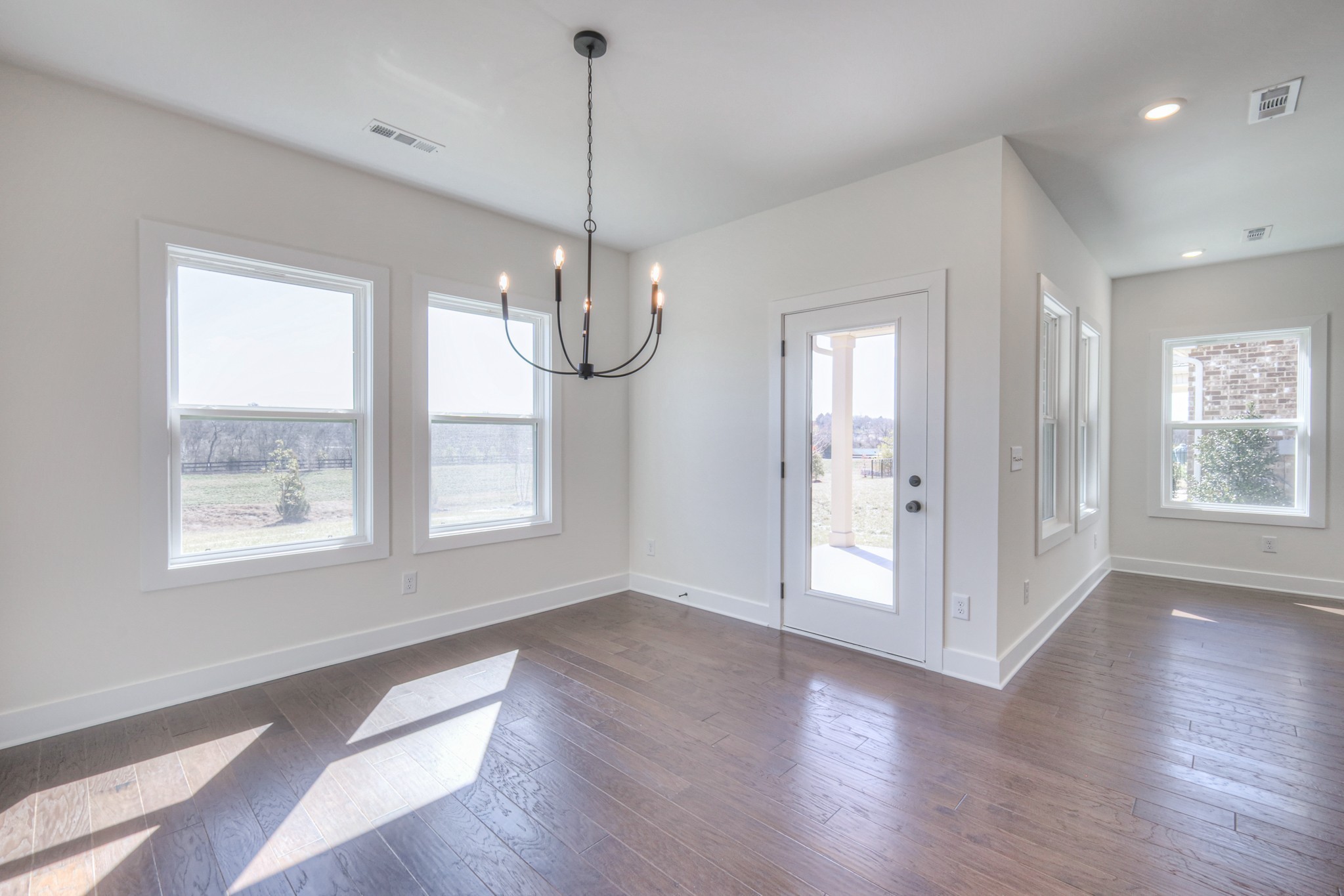 620 Phoebe Way Gallatin, TN 37066 - Photo 19 of 38 a view of an empty room with wooden floor and a window