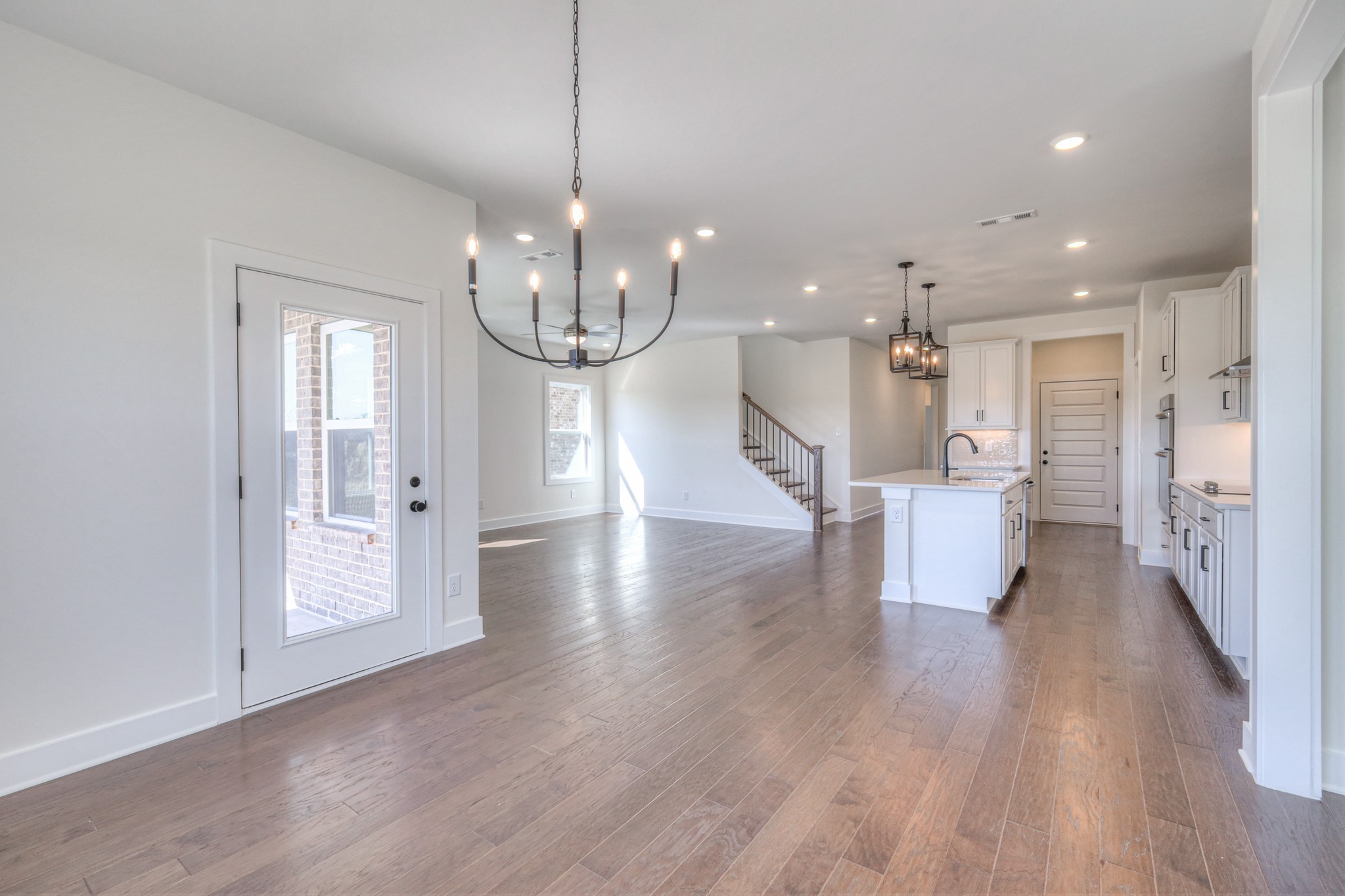 620 Phoebe Way Gallatin, TN 37066 - Photo 20 of 38 a view of a dining room with furniture wooden floor kitchen and chandelier