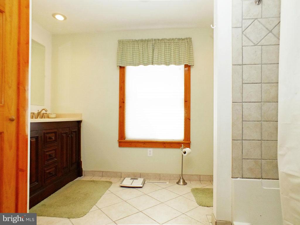19121 Falls Road Hampstead, MD 21074 - Photo 11 of 26 a bathroom with a sink and a shower
