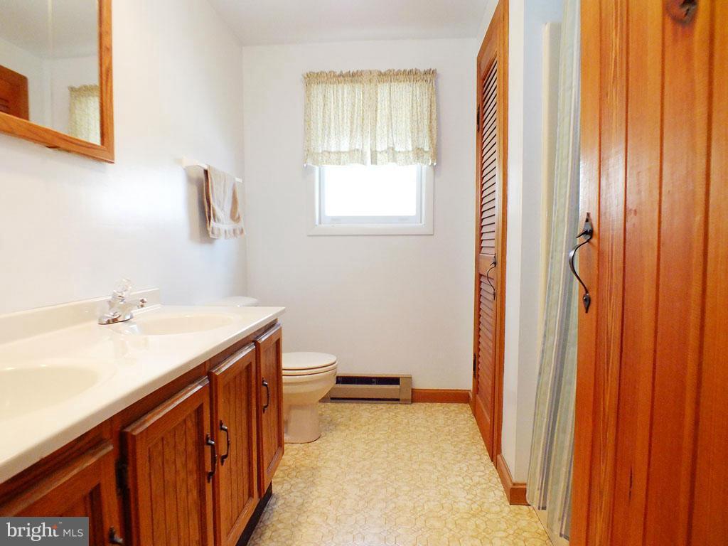 19121 Falls Road Hampstead, MD 21074 - Photo 16 of 26 a bathroom with a sink and a bathtub