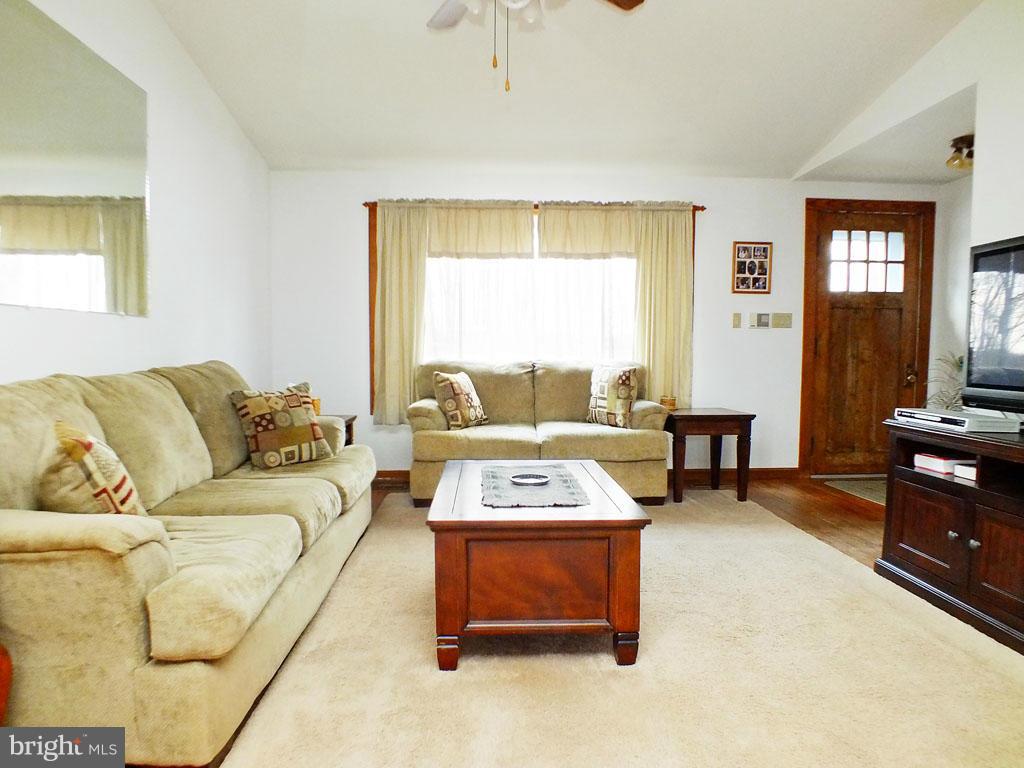 19121 Falls Road Hampstead, MD 21074 - Photo 3 of 26 a living room with furniture and a flat screen tv
