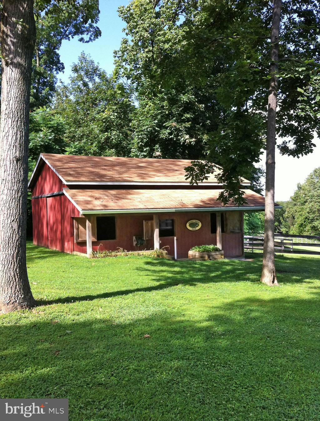 19121 Falls Road Hampstead, MD 21074 - Photo 23 of 26 a view of a big house in a big yard with large trees