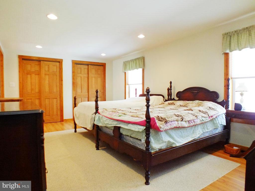 19121 Falls Road Hampstead, MD 21074 - Photo 9 of 26 a bedroom with a bed and wooden floor