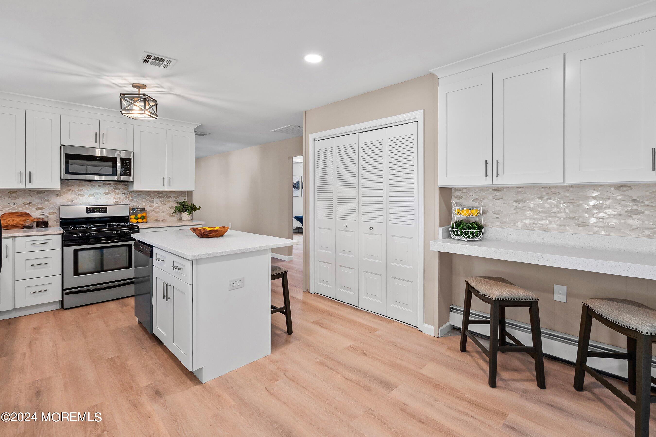 21 Tapola Road Toms River, NJ 08757 - Photo 13 of 22 a kitchen with a sink cabinets and stainless steel appliances